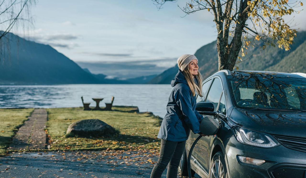 Woman using EV charging on her car